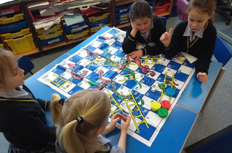 Playing snakes and ladders at Burgess Hill Girls