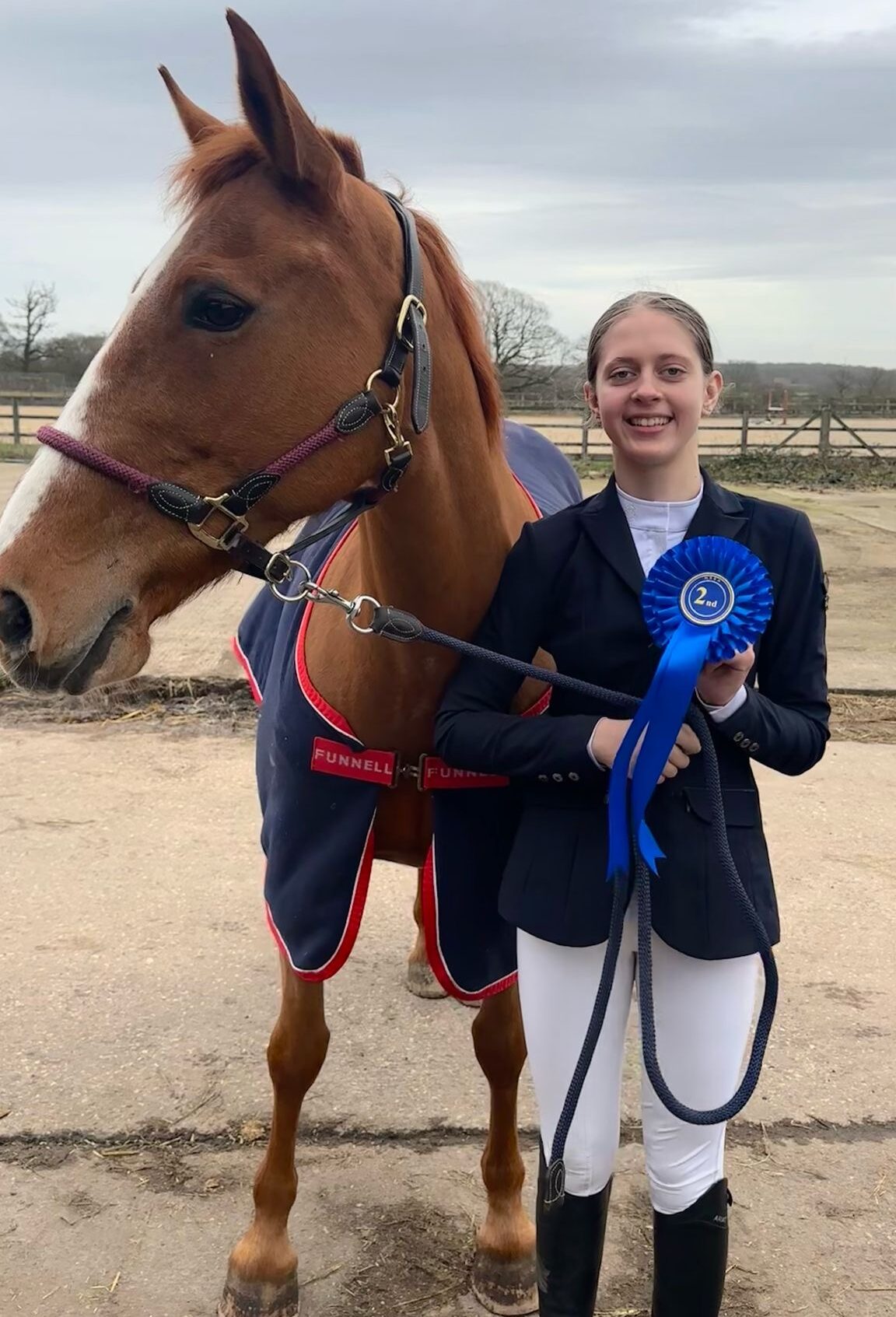 Student Violetta standing with Horse at Equestrian Competition